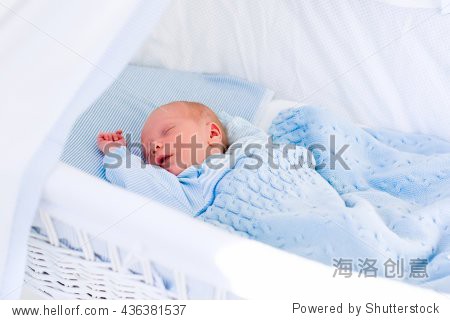newborn baby boy in bed. new born child sleeping
