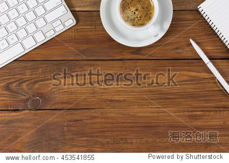 business composition with white computer keyboard coffee mug pen