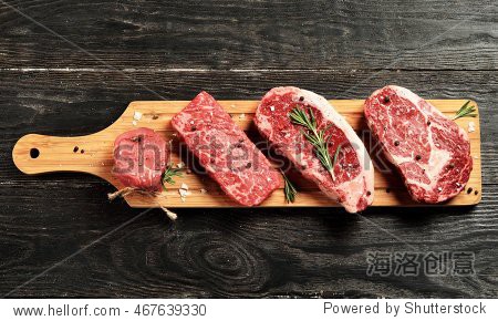 black angus beef steaks on wooden board: tenderloin denver cut