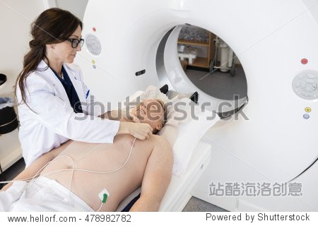 Doctor Preparing Patient For CT Scan In Hosp