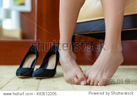 closeup of woman barefoot with painful toes has removed her