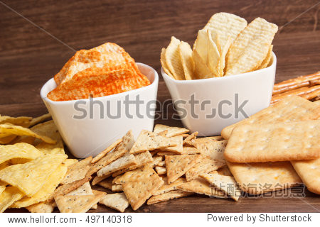 heap of crunchy salted potato crisps and cookies