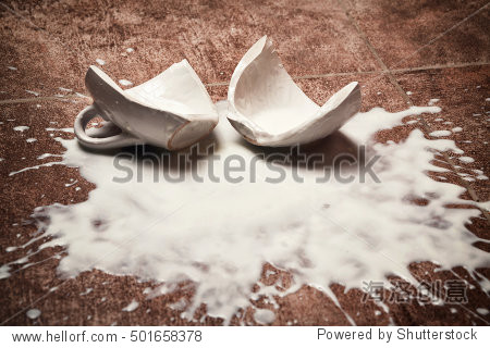 a broken cup and spilled yogurt on the floor