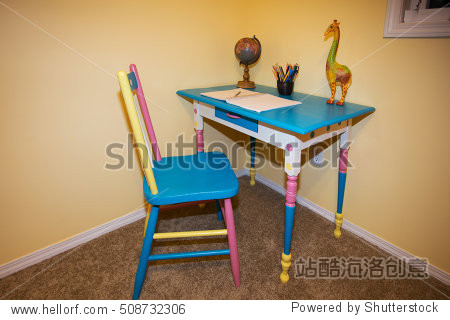 a small colorful childrens desk and chair with
