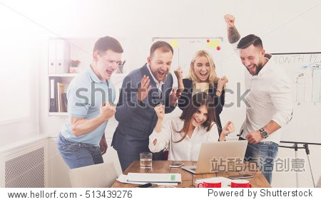 happy business people celebrate success looking at laptop screen