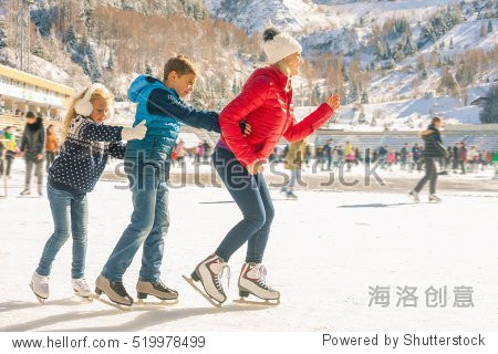 happy family outdoor ice skating at rink. winter activities