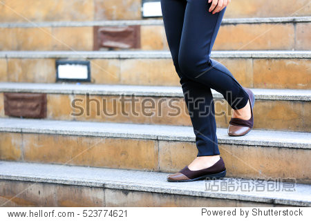 walking downstairs: close-up view of woman"s leather shoes