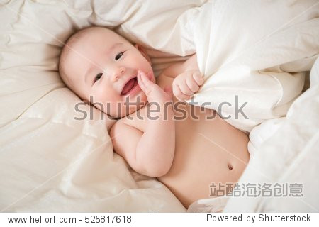 young mixed race chinese and caucasian baby boy having fun in