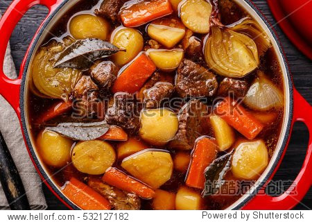 beef meat stewed with potatoes, carrots and spices in cast iron