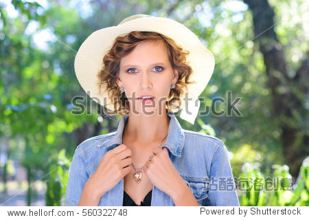 the beautiful young girl with blue eyes in a hat and a jeans