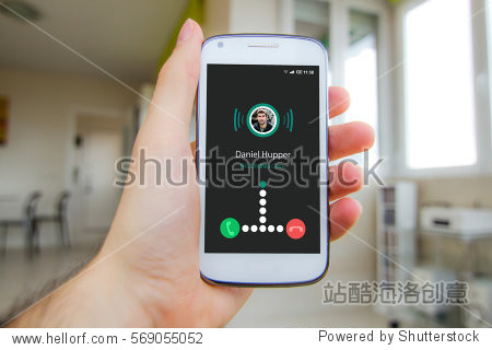 man"s hand holding smartphone with incoming call on the screen