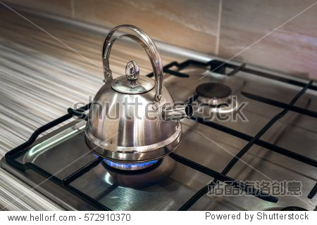 iron kettle is on the home gas stove and boil