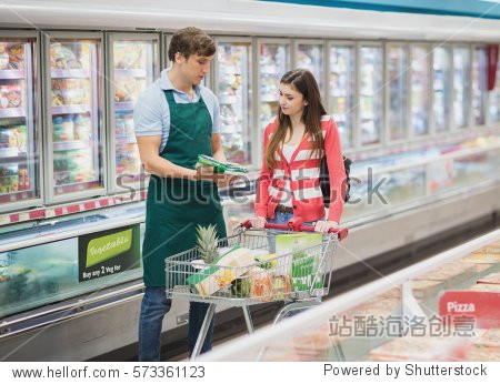 a man grocer advising his customer on a grocery