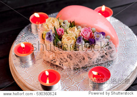 classic valentines day heart-shaped cake with candles and flower