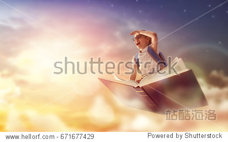 Back to school! Happy cute industrious child flying on the book on background of sunset sky. Concept of education and reading. The development of the imagination.