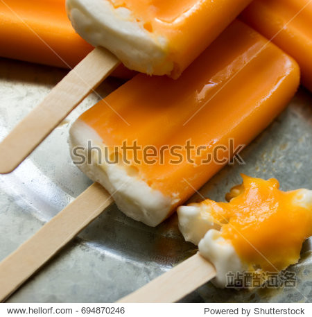 a bunch of orange creamsicle treats on a galvanized tray.