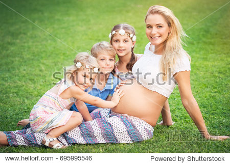 mother of many children cute blond pregnant woman with her three