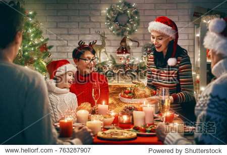 Merry Christmas! Happy family are having dinner at home. Celebration holiday and togetherness near tree.