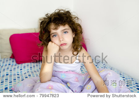 brunette girl bored in her bedroom bed with messy hair