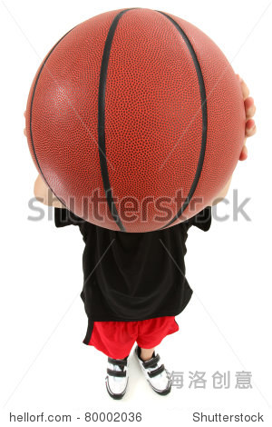 top view of basket ball playing boy child ready to throw ball.