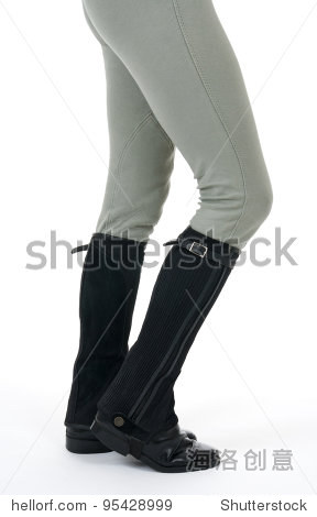 woman wearing horse riding boots and breeches, on