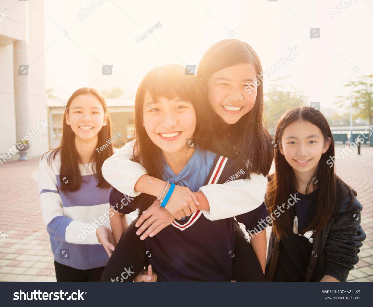 Group Of Teenage Students playing in school
