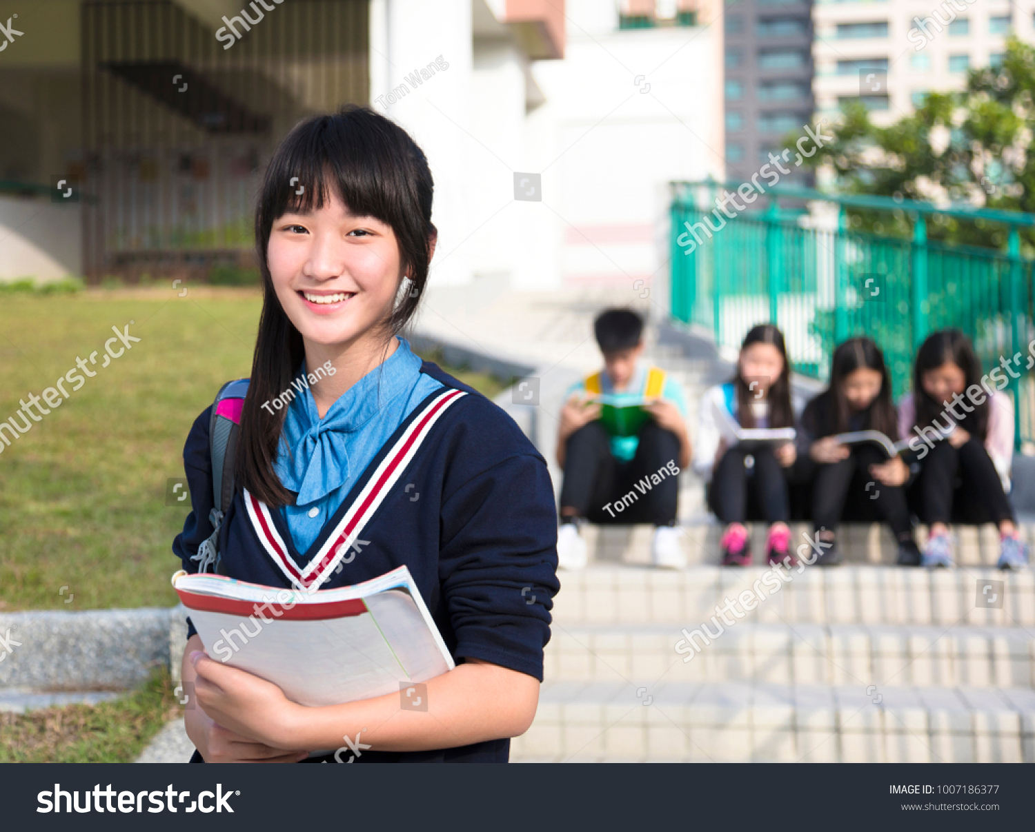 smiling girl Teenage Students standing  at campus