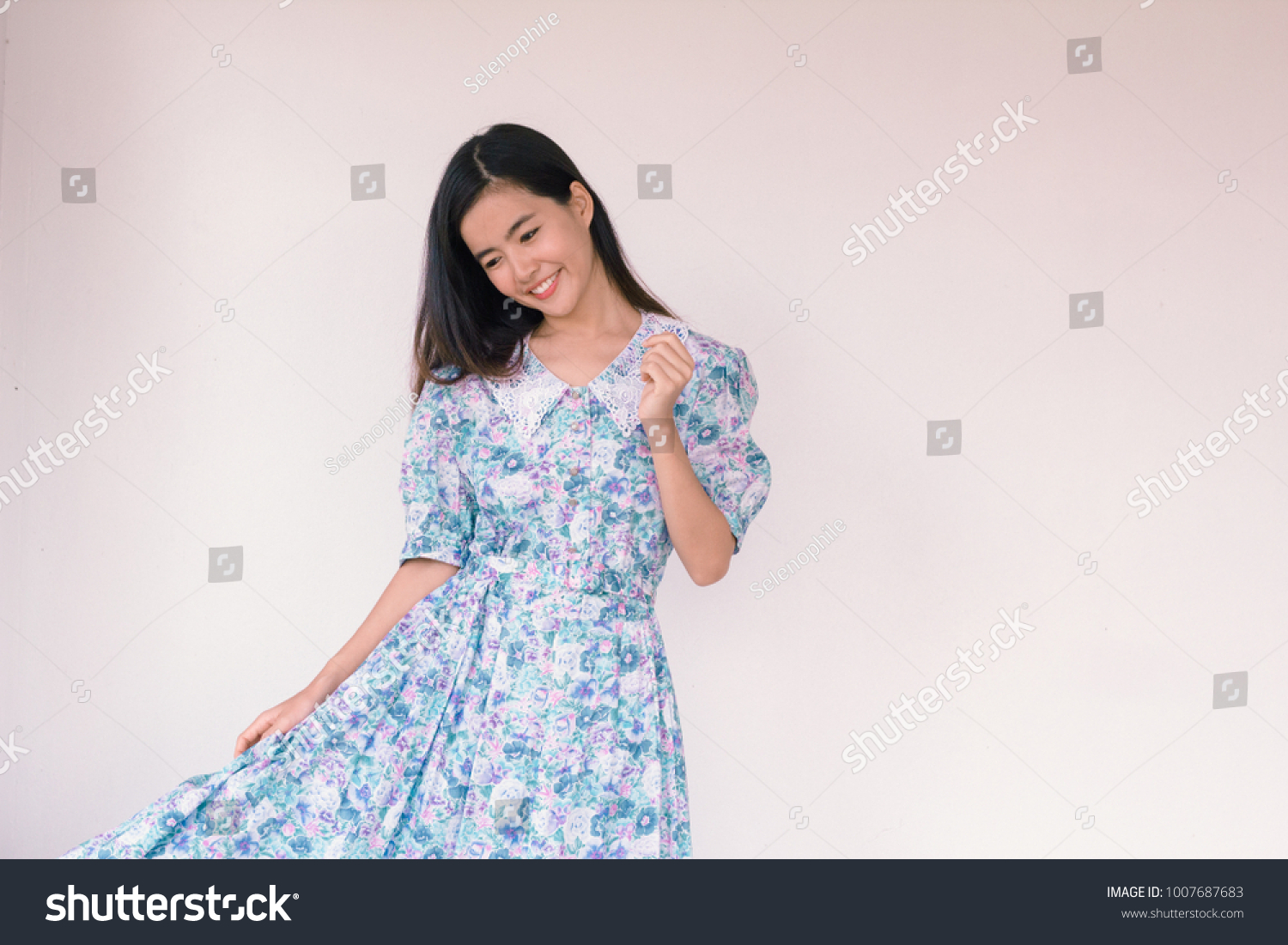Fashion Portrait of Young cute asian woman wearing vintage blue dress 