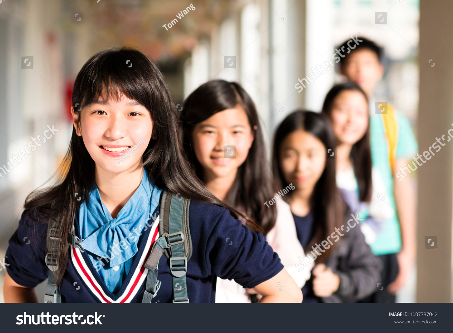 Group Of Teenage StudentsÂ standing before classroom