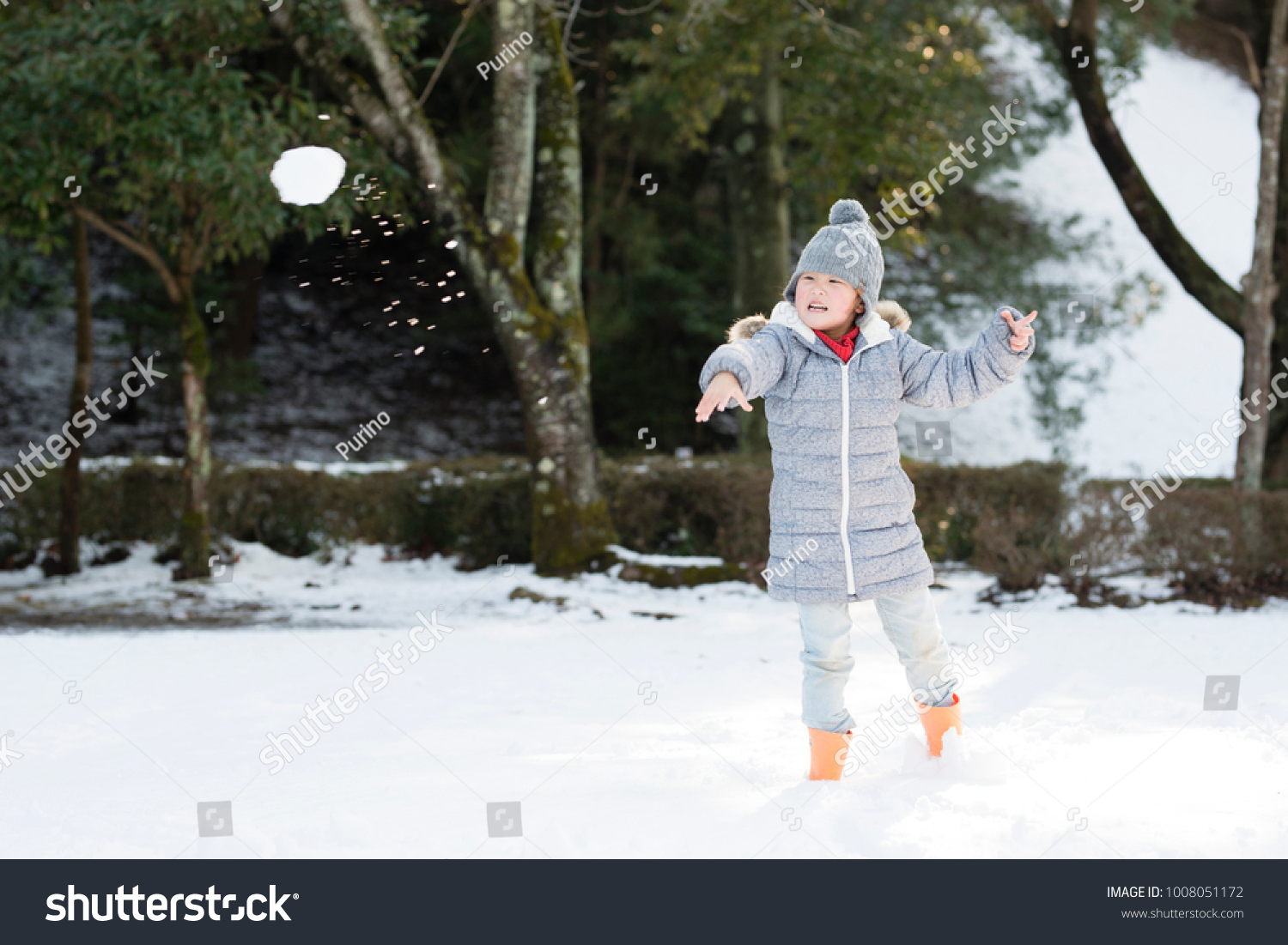 Little girl throwing snowball