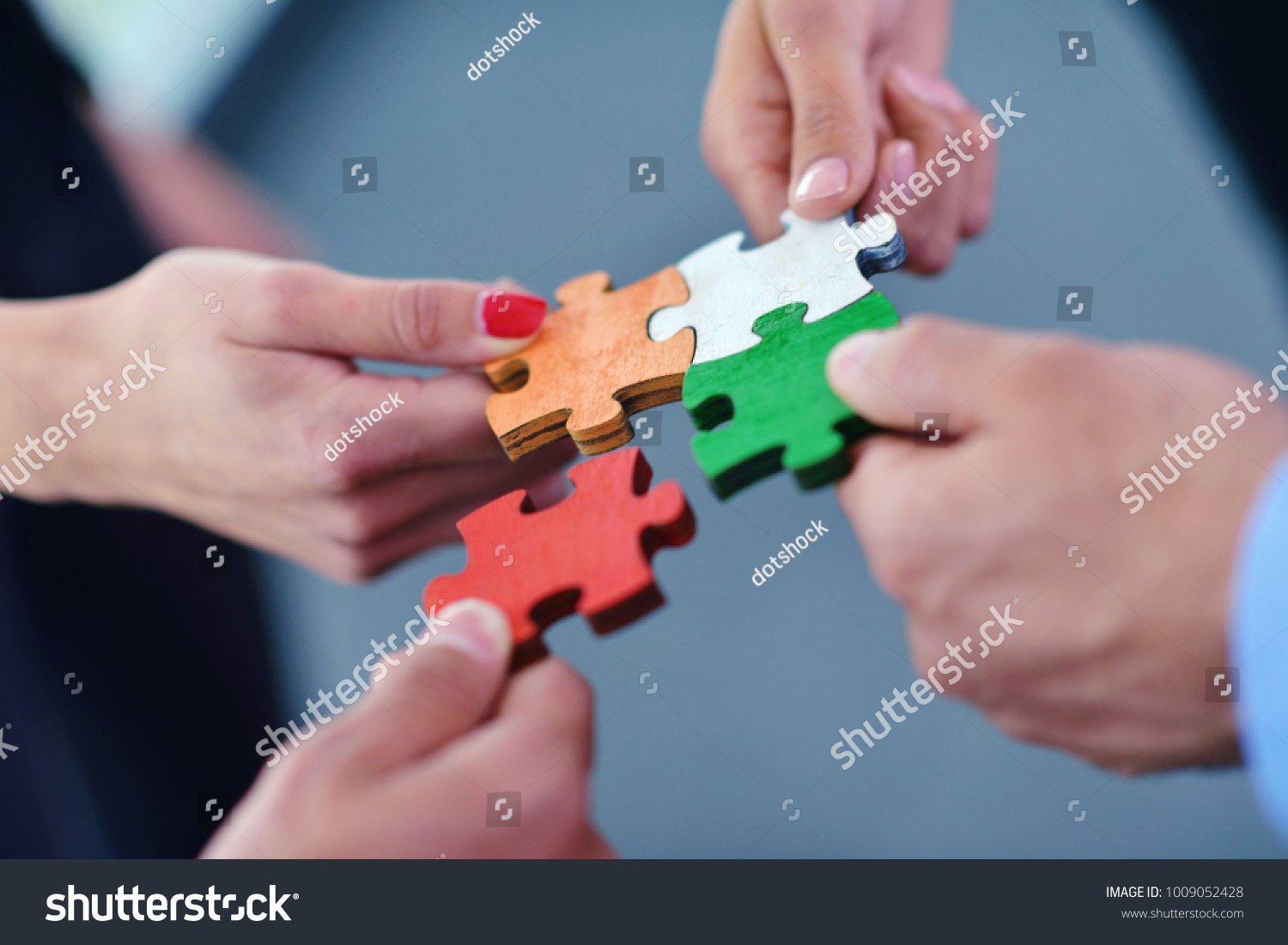 Group of business people assembling jigsaw puzzle and represent team support and help concept
