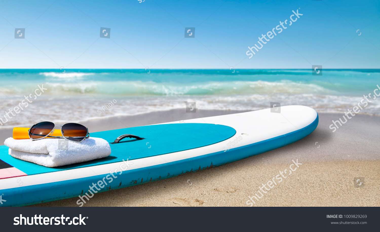 Surfboard and summer time on beach. Free space for your decoration. 