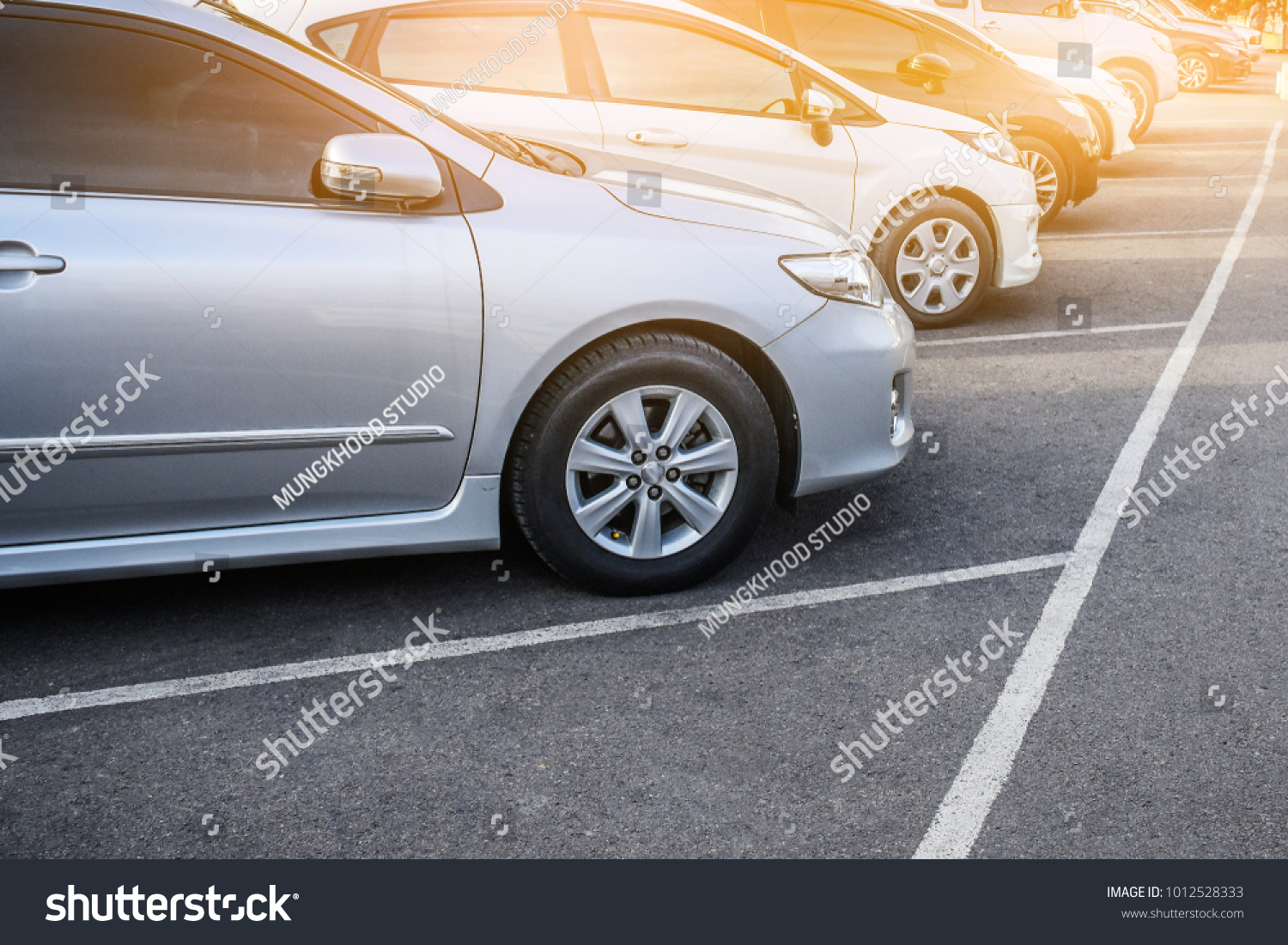 Car parked row on road Car a lot parking in line and sunset