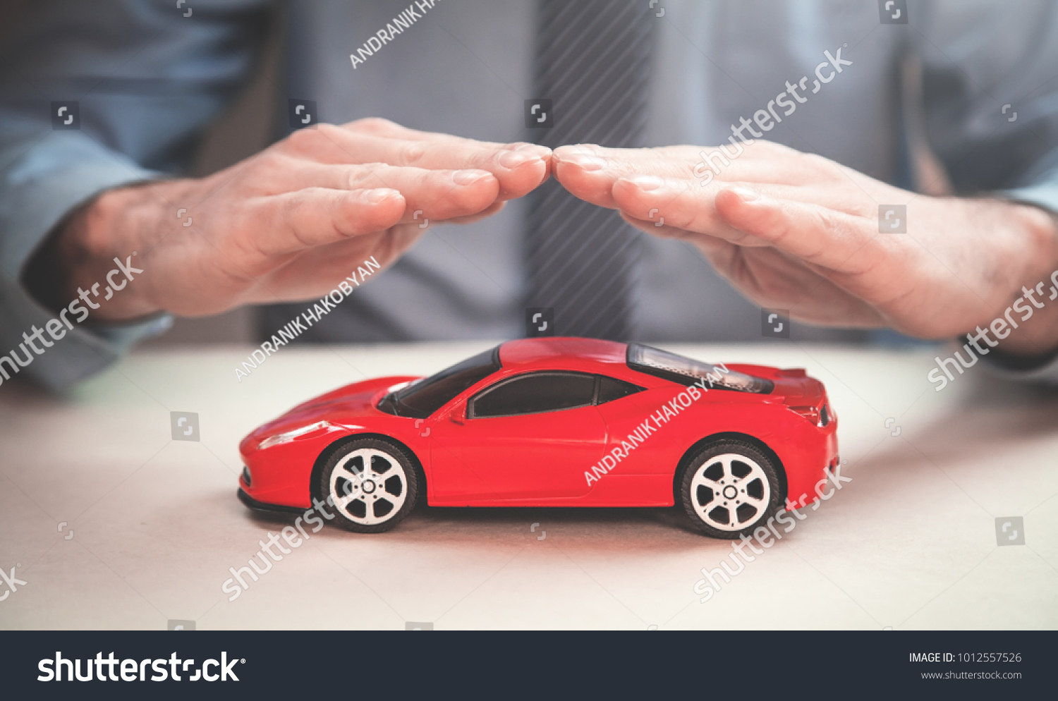 Man protect red car. Car insurance concept.