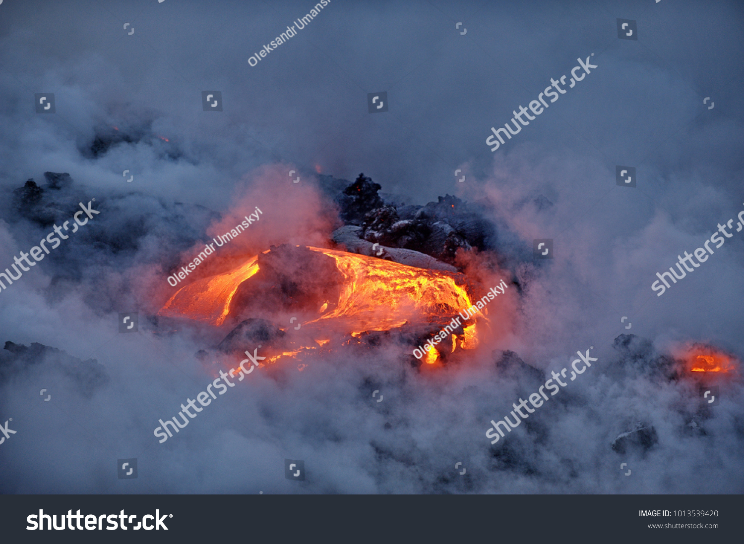 The hot lava of the Hawaiian volcano Kilauea flows into the waters of the Pacific Ocean