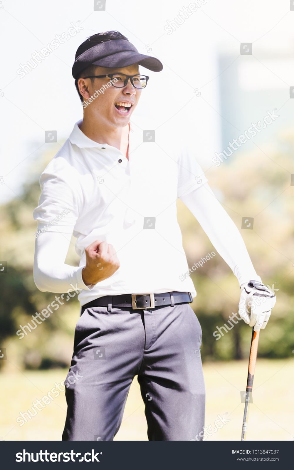 Asian men playing golf. Men play hole in one golf while standing on field