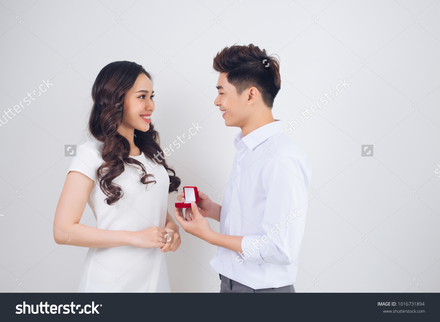 Handsome man showing engagement diamond ring to his girlfriend. Proposed wedding.