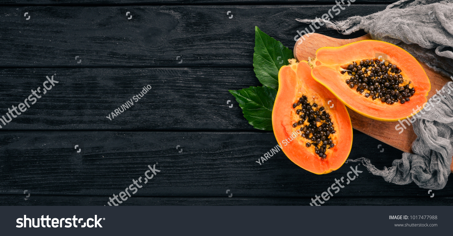 Papaya. Tropical Fruits. On a wooden background. Top view. Copy space.