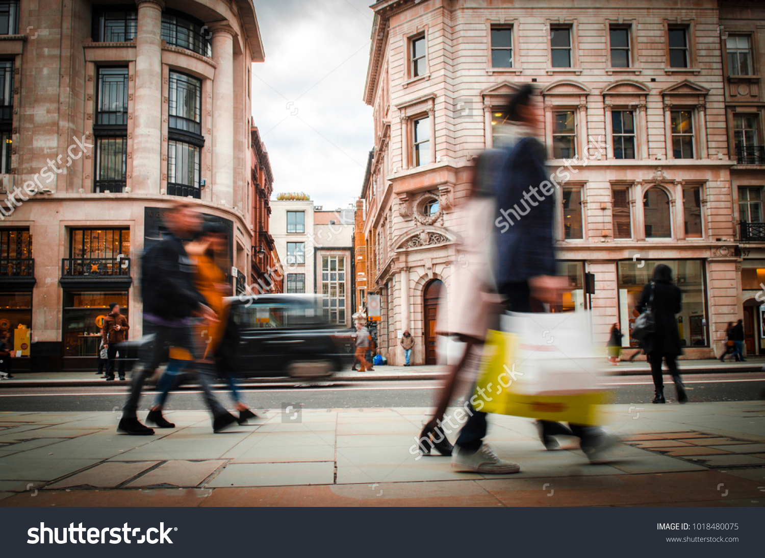 Motion blurred shoppers carrying shopping bags on Regent Street  London. 