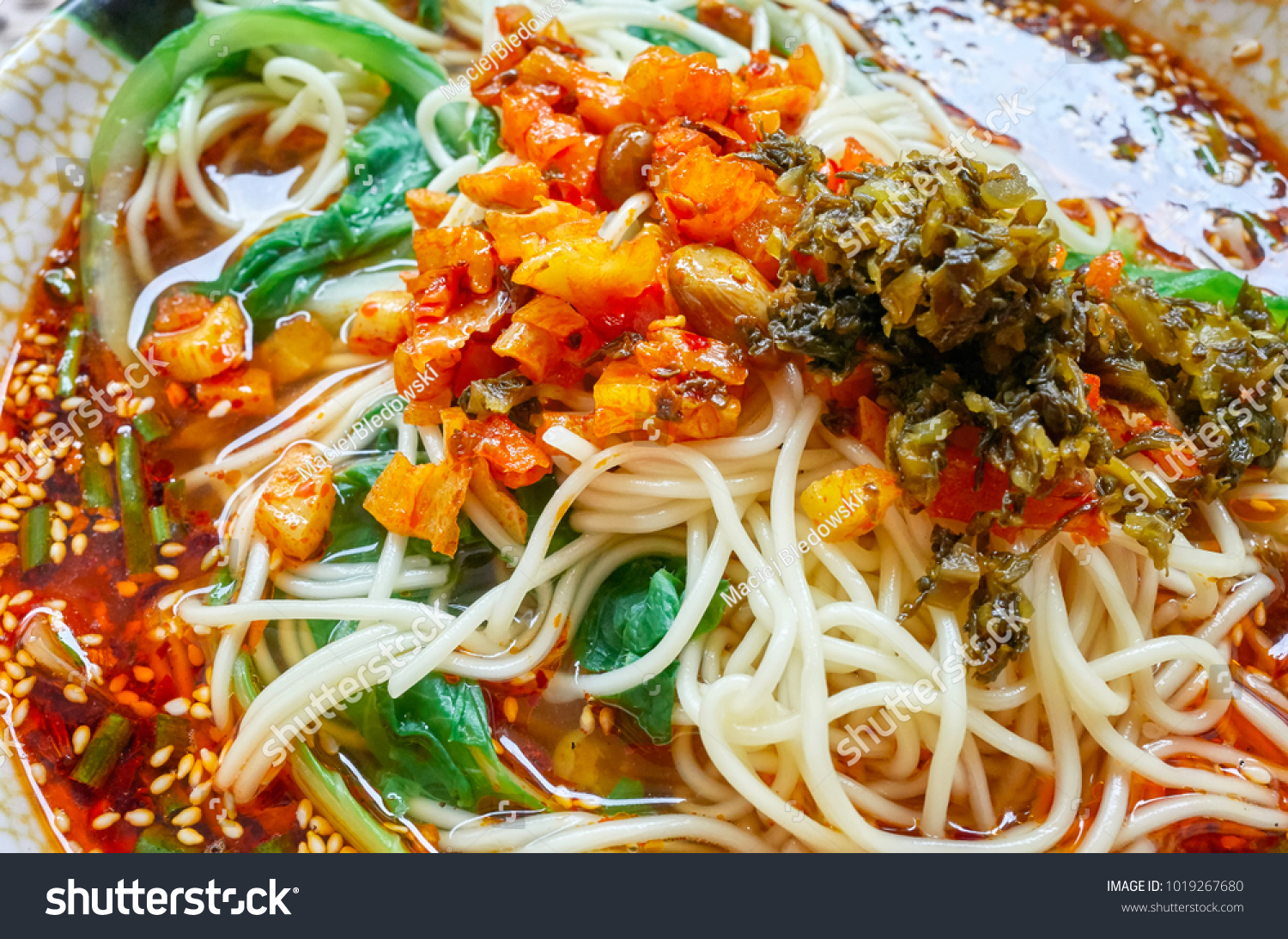 Spicy noodle soup with vegetables herbs peanuts and coriander popular in Yunnan Province shallow depth of field China.