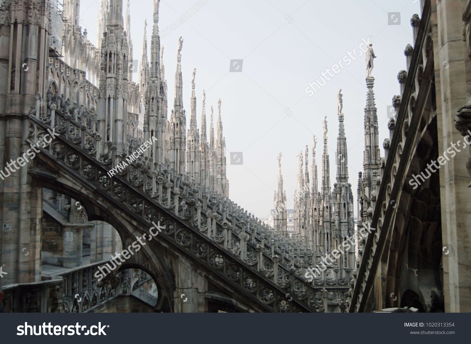 View of architectural detail of Duomo di Milano roofs. Foogy morning. Gloomy gothic