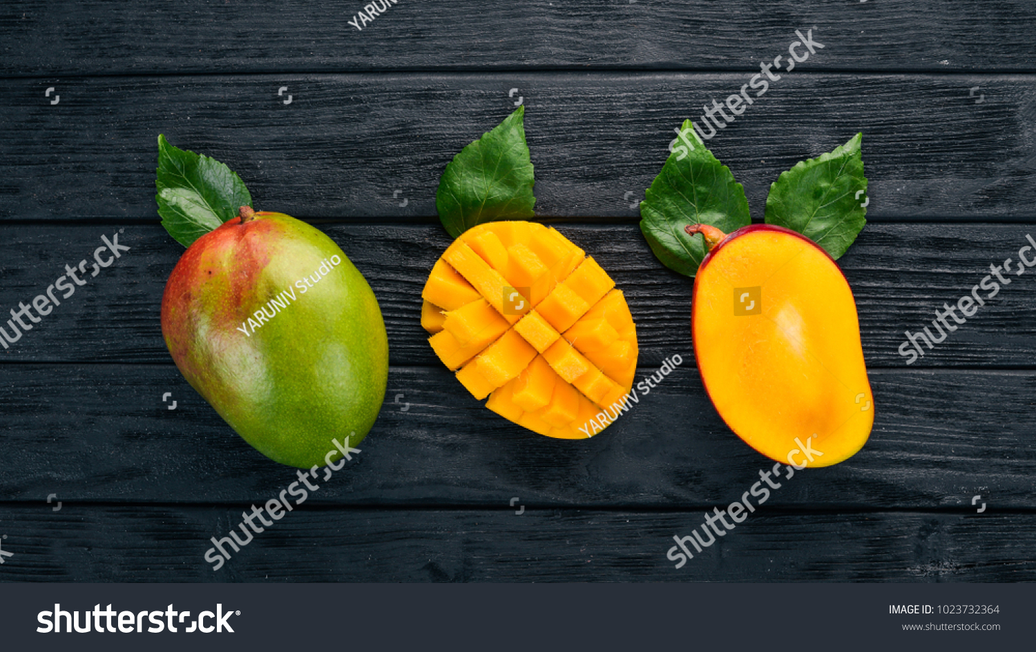 Mango. Tropical Fruits. On a wooden background. Top view. Copy space.