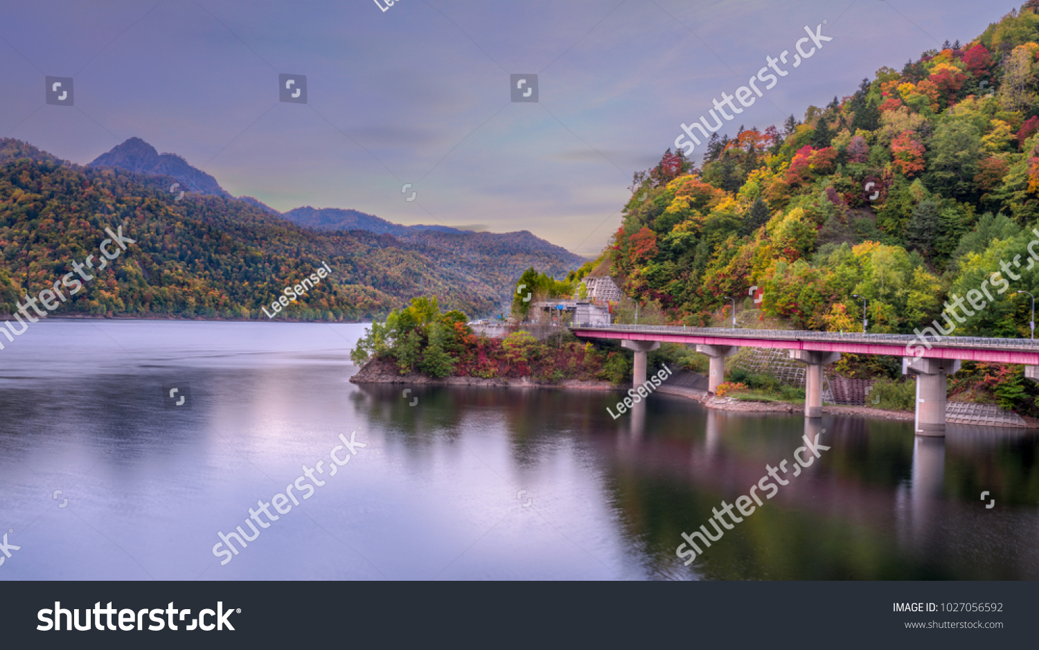 Bridge across the lake in Autumn  with autumn forest on the hill  Hokkaido  Japan