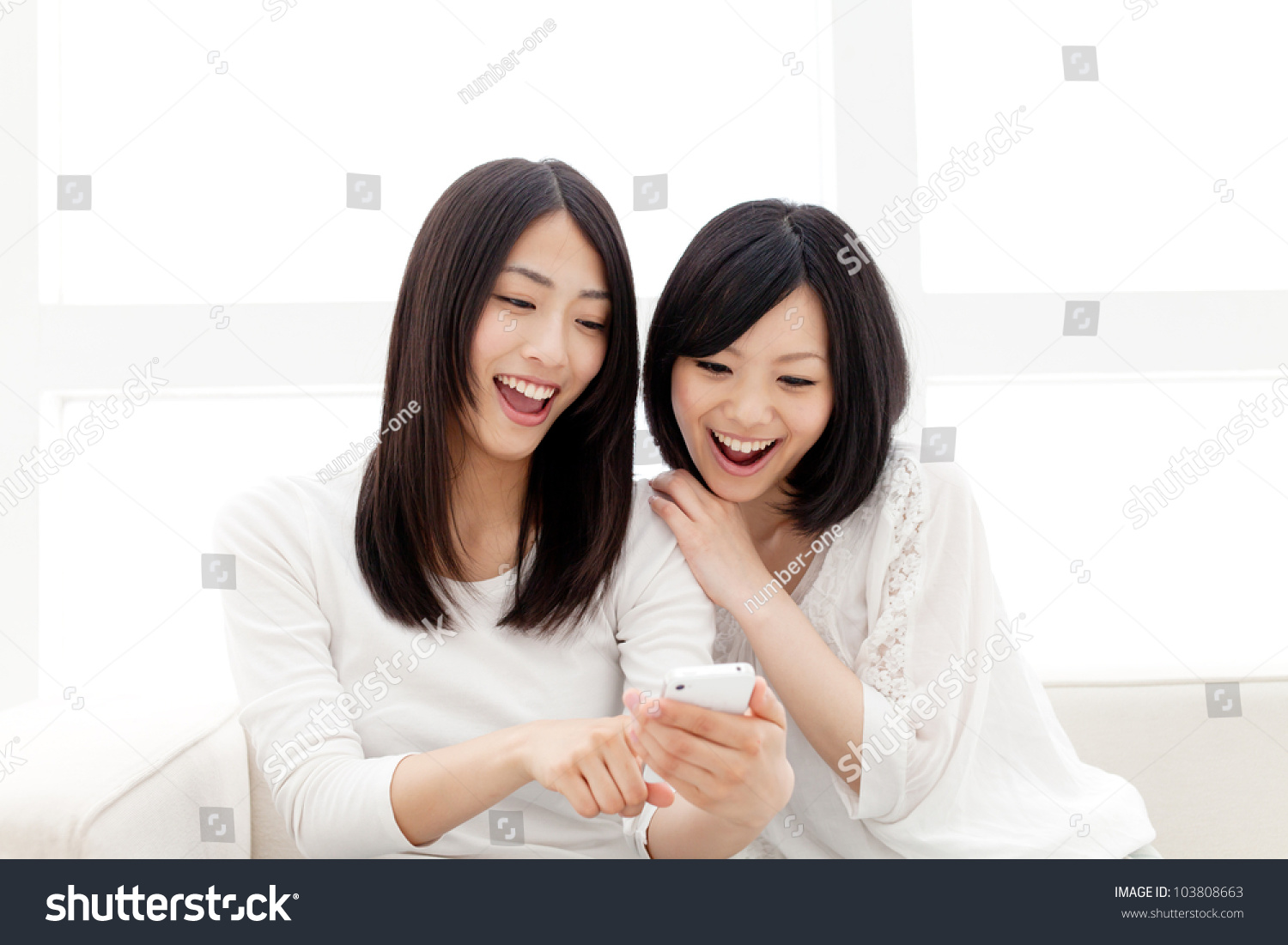 Beautiful young women using a moblie phone. Portrait of asian.