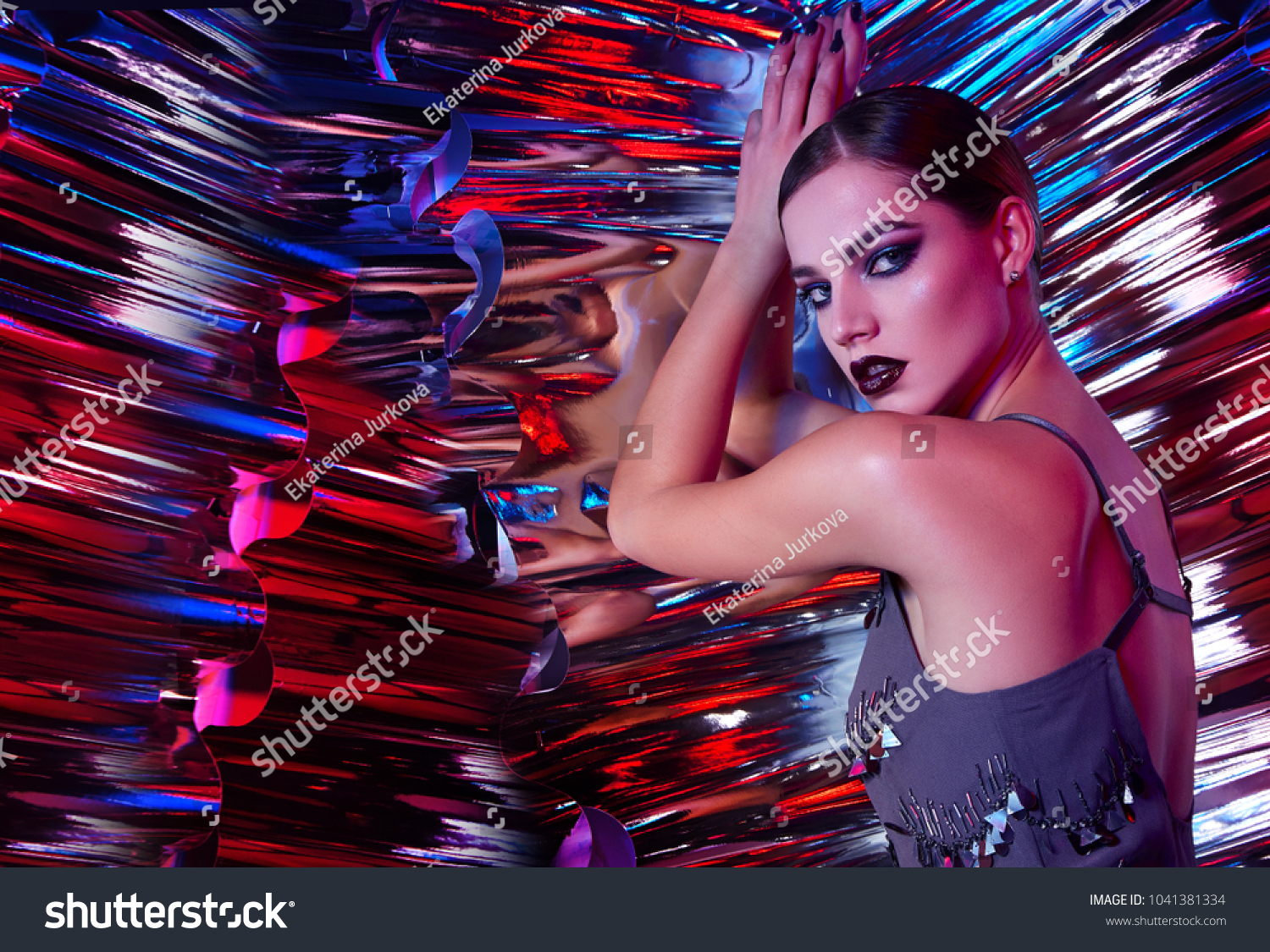 Beautiful young girl in the studio on a multicolored rainbow background - blue blue green pink.