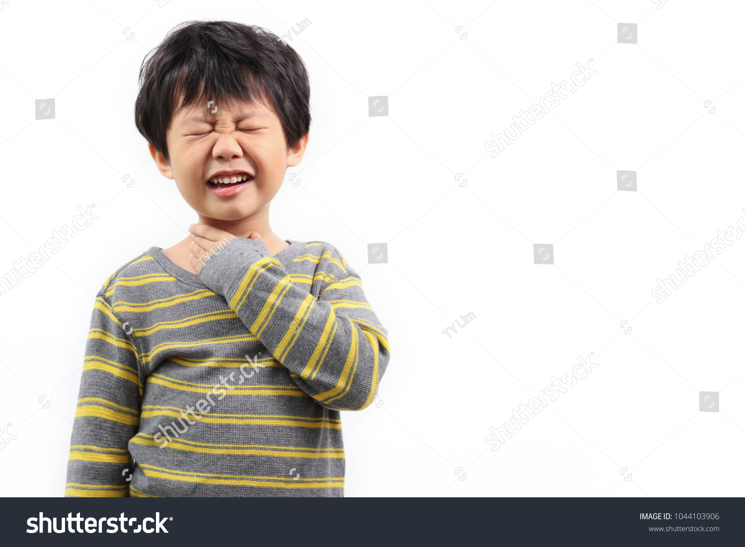 Little Asian boy with sore throat touching her neck  feeling pain in her throat.