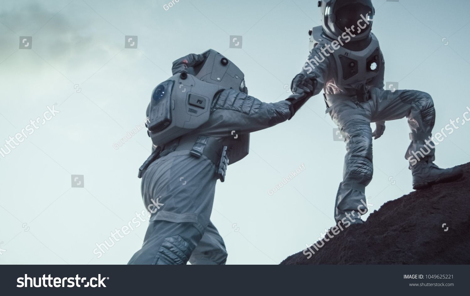 Two Astronauts Climbing Mountain Hill Helping Each Other  Reaching the Top. Overcoming Difficulties  Important Moment for the Human Race.