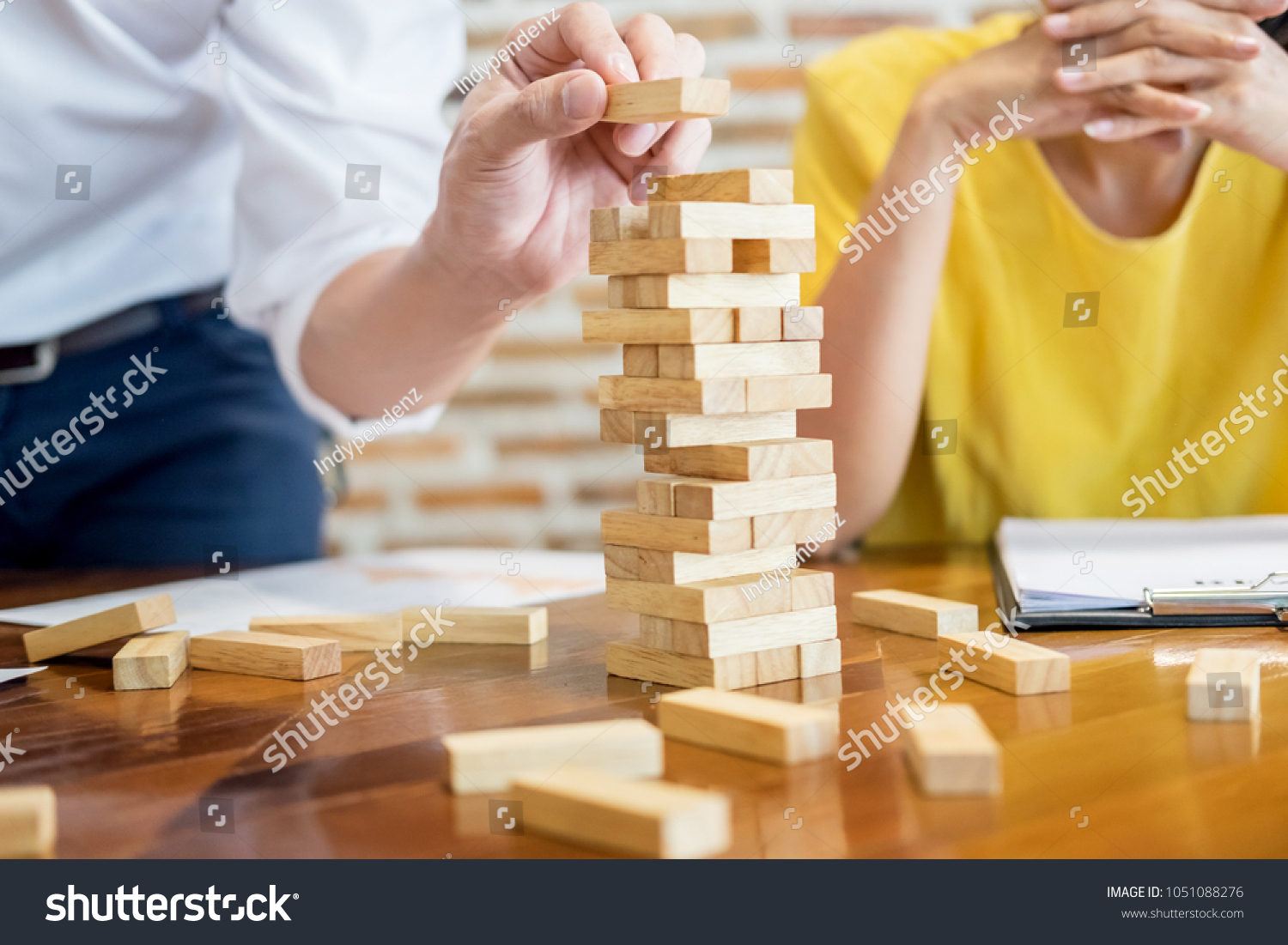 Group of business creative people building tower by wooden blocks  doing a plan for brainstrom business strategy  risk  future  teamwork concept