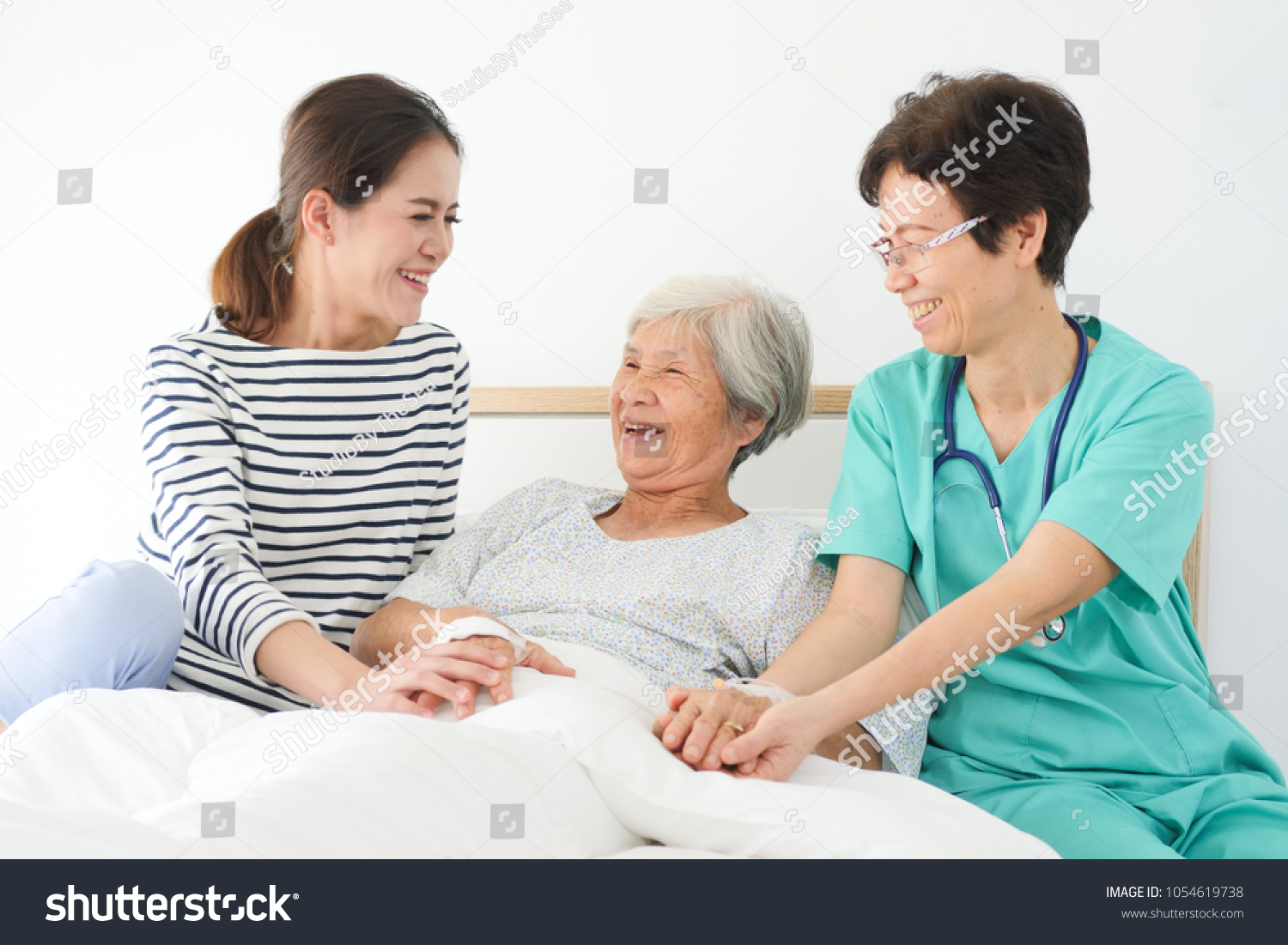 Asian senior woman sick in hospital with daughter and doctor take care in happy and smile mood