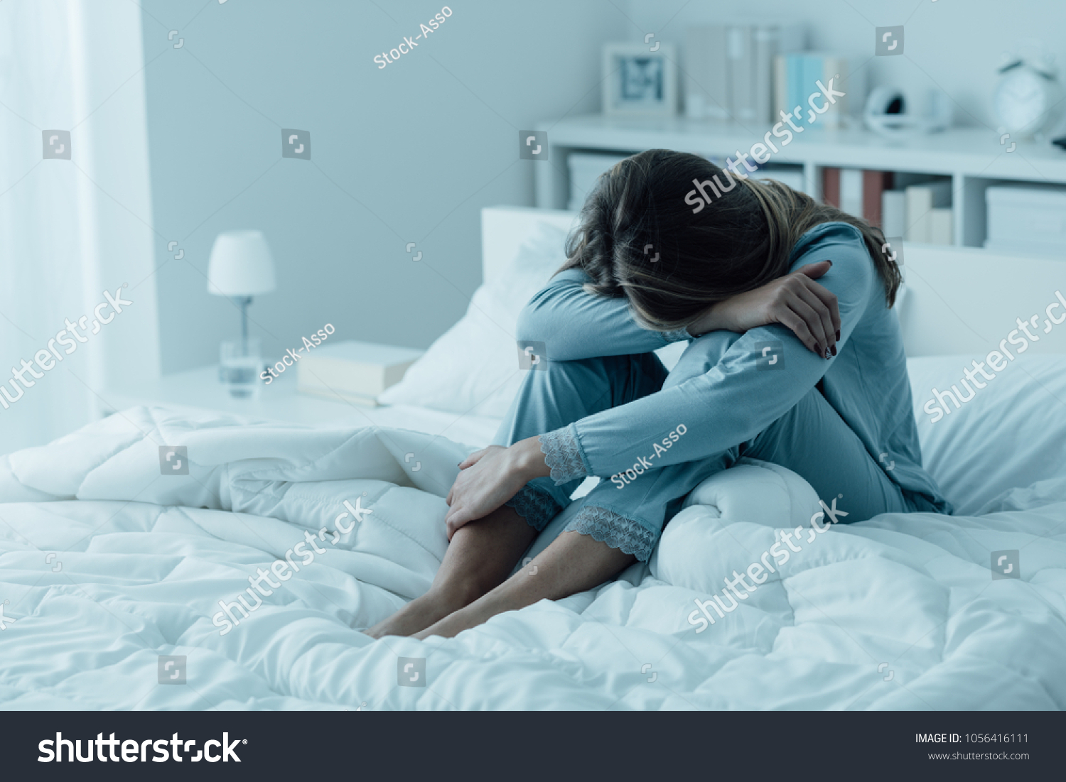 Depressed woman awake in the night  she is exhausted and suffering from insomnia